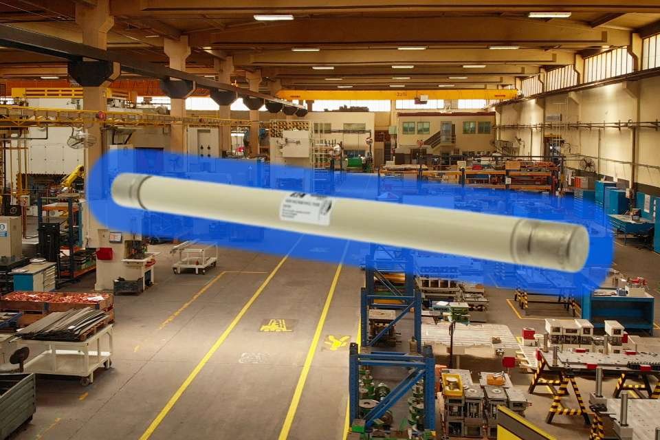 Eaton Bussmann 36ABGNA3.15 Air-Fuse Link digitally highlighted over an industrial factory floor, representing medium-voltage circuit protection.